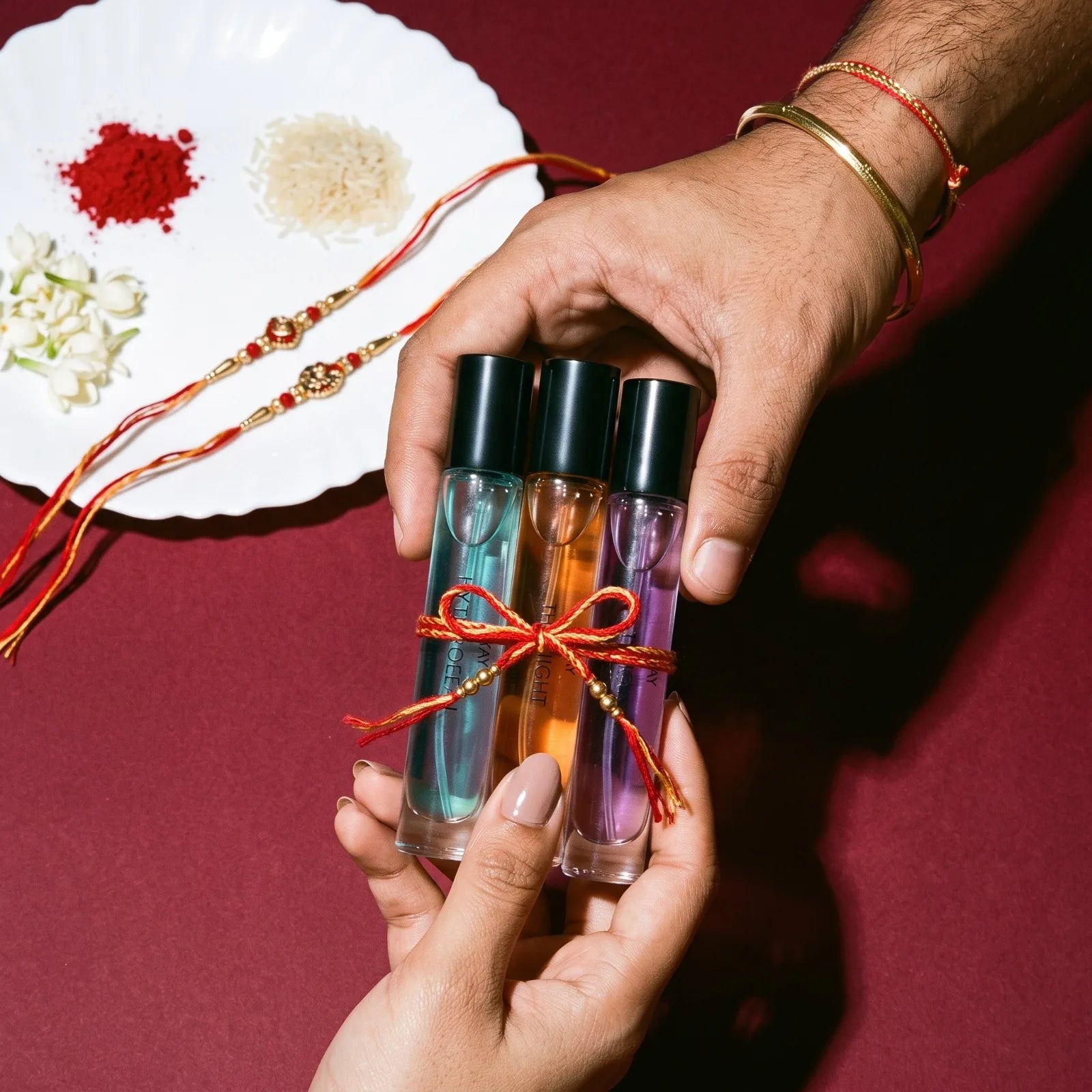 Three STAY 10 mL perfumes tied together as a Rakhi gift